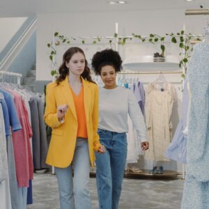 Two women exploring fashion trends in a stylish boutique together.